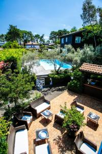 una vista aérea de un patio con sillas y una piscina en Hotel Résidence Le Sporting en Cap-Ferret