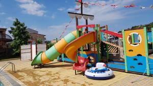 a playground with a slide and a play structure at Apartments Resort BG in Primorsko