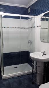 a bathroom with a shower and a sink at Hostal Restaurante Ceres in Magaz De Pisuerga