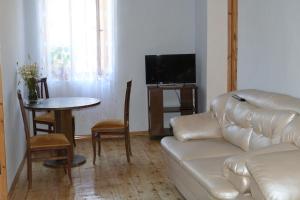 a living room with a couch and a table at Irina's Guesthouse in Mestia