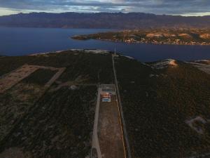 an aerial view of a train track next to a body of water at Villa Melody Novalja in Novalja