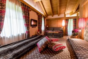 a bedroom with a large bed with pillows on it at Hotel Maso del Brenta in Caderzone Terme
