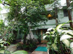 a house with a pool in front of it at Green Woods Bethlehem in Cochin