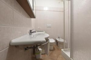a bathroom with a sink and a toilet at Agriturismo Redipuglia in Alberese +65 photos