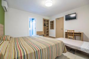 Postel nebo postele na pokoji v ubytování Hotel Blason Junior