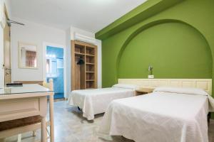 Postel nebo postele na pokoji v ubytování Hotel Blason Junior