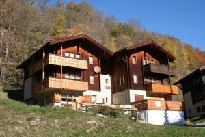 a large apartment building with balconies on a hill at Danica in Blatten bei Naters