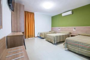Postel nebo postele na pokoji v ubytování Hotel Blason Junior