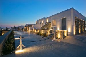 a building with lights on the side of it at night at Nida Mykonos in Mikonos