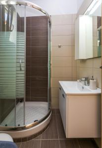 W łazience znajduje się prysznic i umywalka. w obiekcie Aglaia Studios w mieście Skala Marion