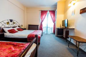Postel nebo postele na pokoji v ubytování Hotel Onix + 32 fotografií