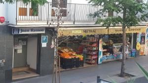 a store front of a grocery store with fruits and vegetables at Pensión Juan Ramón in Lloret de Mar