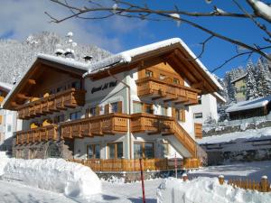 a house in the snow with snow at Hotel Al Viel B&B in Canazei