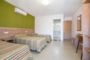 Postel nebo postele na pokoji v ubytování Hotel Blason Junior