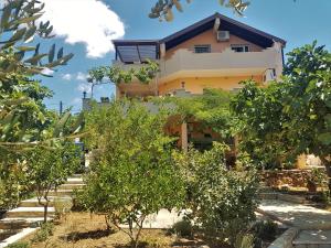 a building with trees in front of it at Apartments Villa Marija in Gornji Karin