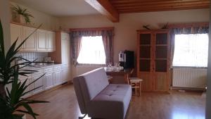 a living room with a couch and a chair in a kitchen at Gartler's Ferienhaus in Weitersfeld an der Mur