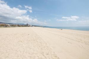 a beach with footprints in the sand and the ocean at Matarolux 9 in Mataró