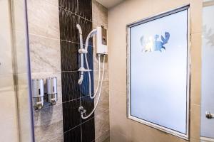 
a bathroom with a toilet and a shower stall at Maneetel Krabi Beachfront-SHA Plus in Ao Nang Beach
