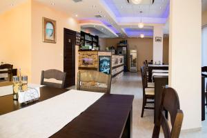 a dining room with a table and chairs at Ivatea Family Hotel in Ravda