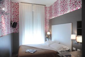 Postel nebo postele na pokoji v ubytování Hotel Astoria