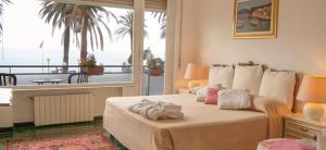 a bedroom with a bed with a view of the ocean at Il Ponentino in Varazze