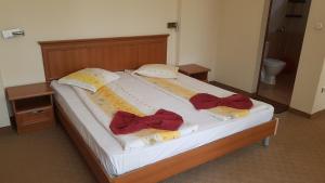 a large bed with two pillows on it at Guest House Markovi Aheloy in Aheloy