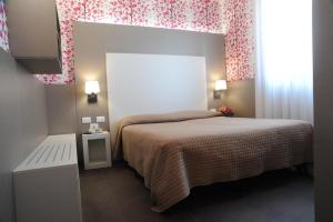 Postel nebo postele na pokoji v ubytování Hotel Astoria
