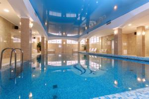 a large swimming pool in a building with blue water at Relita-Kazan Hotel in Kazan