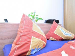 Duas almofadas em cima de uma cama em Apartment with views of the Ore Mountains em Oelsnitz