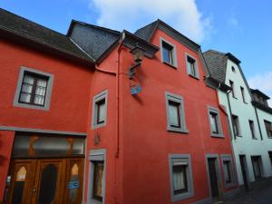 a red building with a black roof at Charming Holiday Home in Neumagen Dhron in Neumagen-Dhron