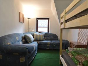 a living room with a couch and a bunk bed at Charming Holiday Home in Neumagen Dhron in Neumagen-Dhron