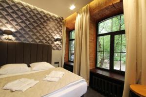 Кровать или кровати в номере Бутик-отель Веллион Бауманский