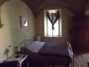 a bedroom with a bed and a window at Il Poggiale in Empoli