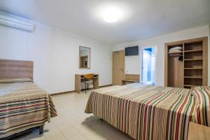 Postel nebo postele na pokoji v ubytování Hotel Blason Junior