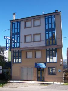 a hotel building on the corner of a street at Pensión Os Ancares in Becerreá