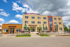 a building with a sign on top of it at Hotel Olympionik in Mělník