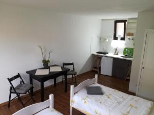 a small room with a table and a kitchen at Bright Side Studios in Ljubljana +27 photos