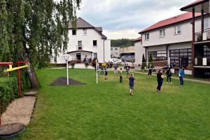 a group of people playing a game in a yard at Paleo Premium in Władysławowo