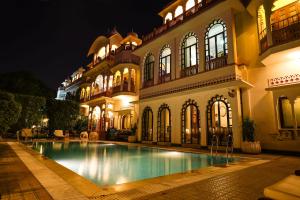 uma casa com piscina em frente a um edifício em Shahpura House em Jaipur