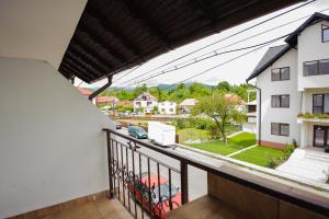 an apartment balcony with a view of a street at Hotel Horezu in Horezu