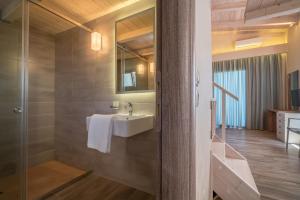 a bathroom with a sink and a mirror at Fiore Beach Studios in Vasilikos