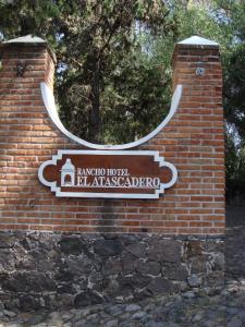 a brick building with a sign on the side of it at Rancho Hotel Atascadero in San Miguel de Allende