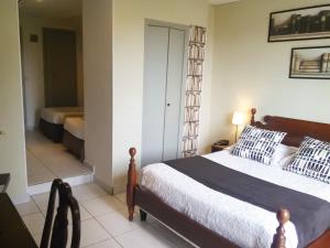Postel nebo postele na pokoji v ubytování Le Panoramic Boutique Hôtel
