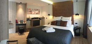 a bedroom with a large bed with towels on it at Moselapart in Cochem
