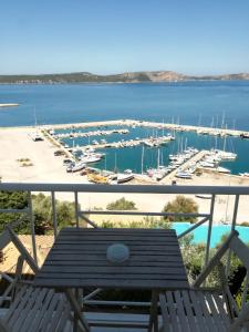 a balcony with a view of a marina at 12 Gods Resort in Pylos
