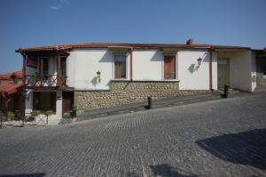 a house on the side of a cobblestone street at Leli in Sighnaghi