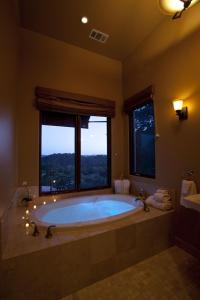ein großes Bad mit einer großen Badewanne und einem Fenster in der Unterkunft Dunning Vineyards Guest Villa in Paso Robles