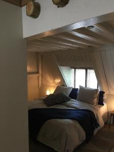 a bed in a room with an attic at bednextdoor in Middelburg