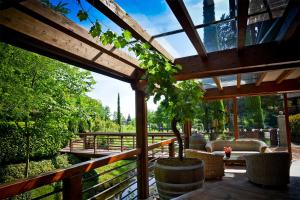 a patio with chairs and a table and a fence at Venica & Venica Wine Resort in Dolegna del Collio