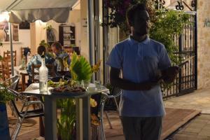 a man standing in front of a table with food at Hotel Kolagji in Himare